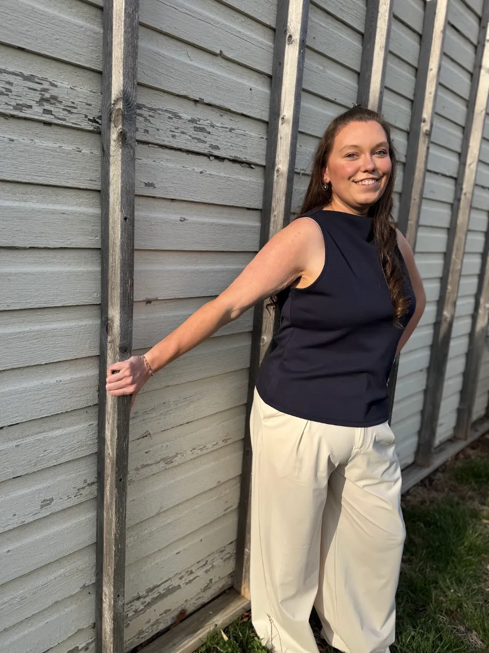 About SJ Digital Solutions | SEO Experts & Content Strategists 9 Samantha Hawrylack, founder of SJ Digital Solutions, standing against a gray siding wall