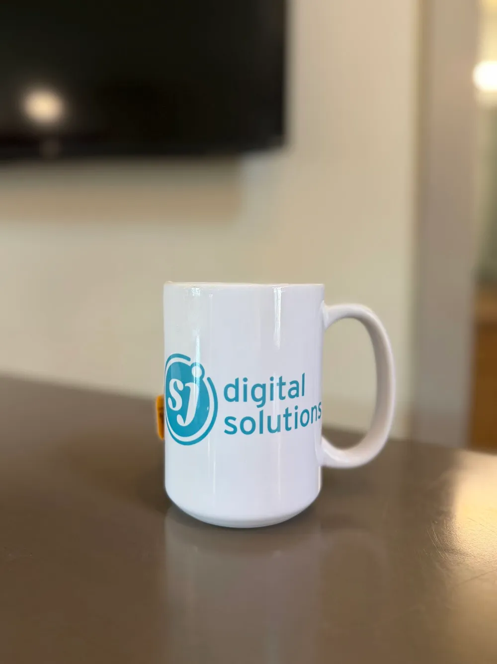 About SJ Digital Solutions | SEO Experts & Content Strategists 8 SJ Digital Solutions branded coffee mug on a desk